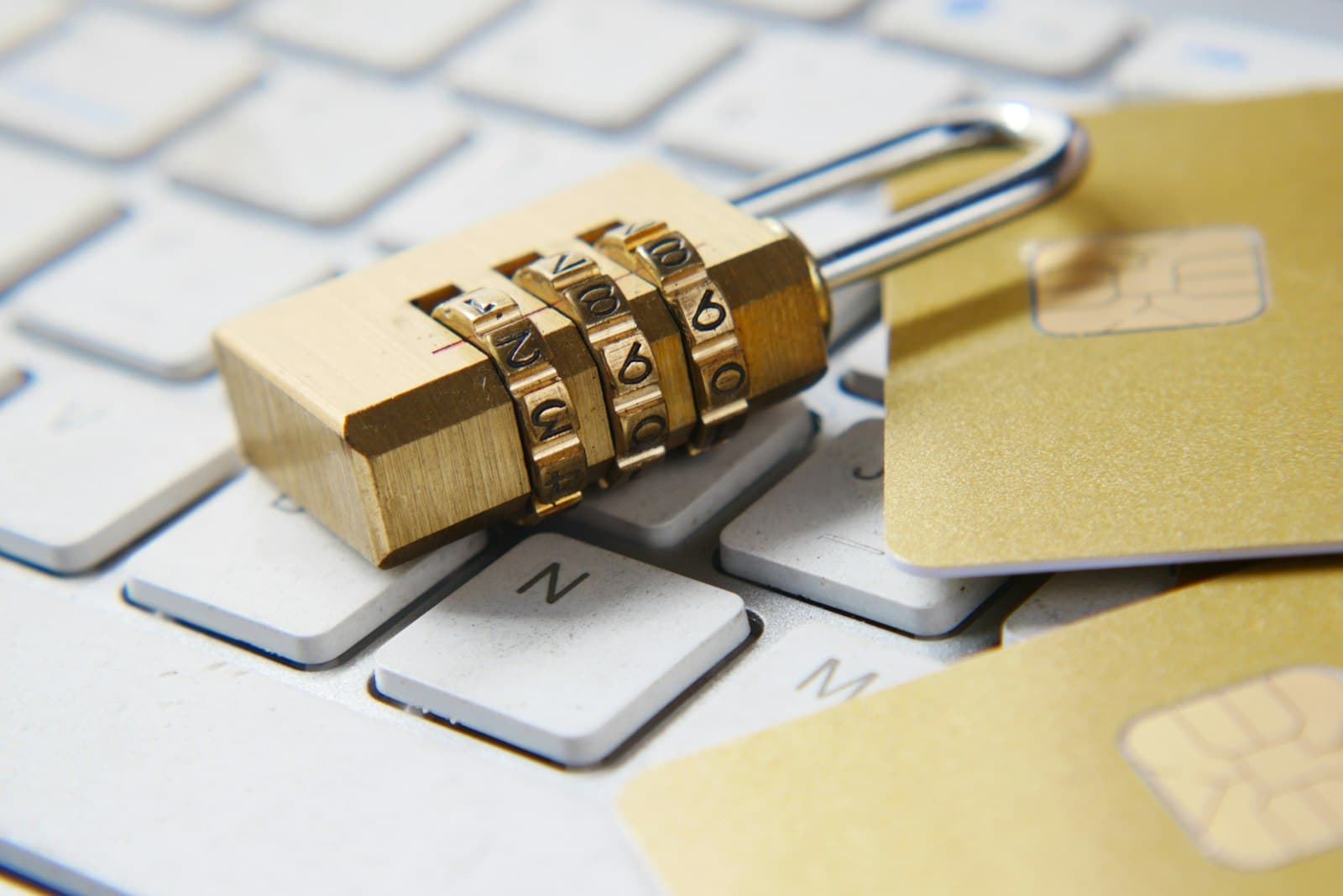 A gold padlock resting on a laptop keyboard